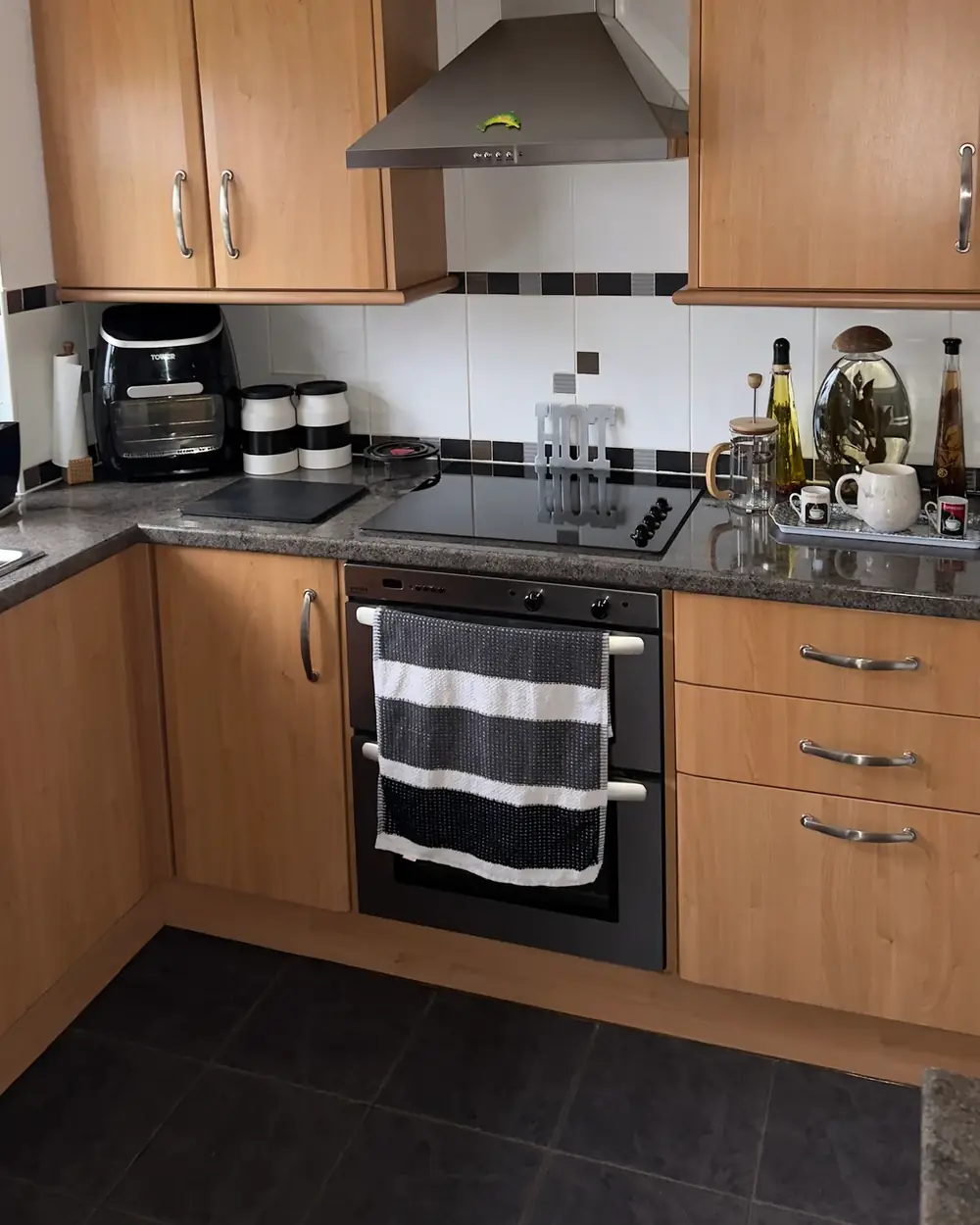Before: Kitchen cabinets sprayed in Perfectly Taupe, worktops sprayed in Fossil Stone effect